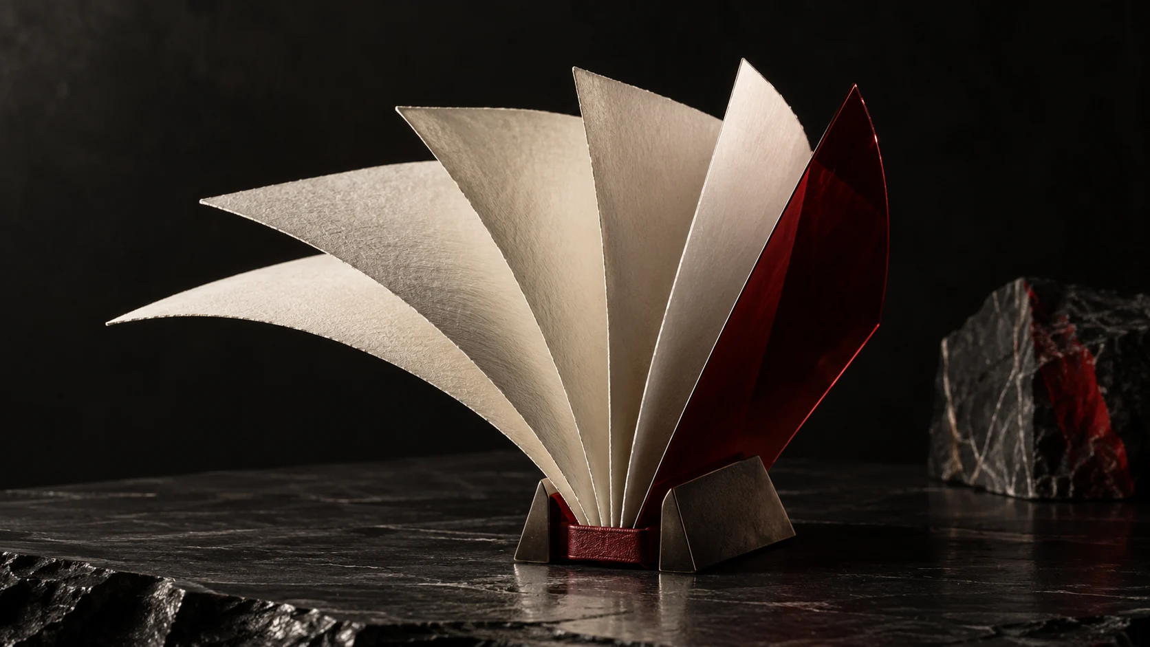 Sculptural paper folio with a garnet glass leaf — concept artwork
